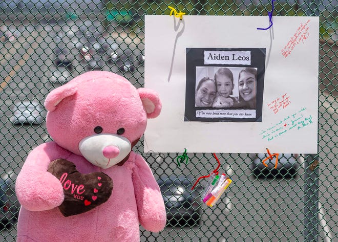 Un gran oso de peluche y una valla publicitaria decorada con una foto y notas son parte de un monumento en un paso elevado en Orange, California, a Aiden Leos, de 6 años, quien fue asesinado a tiros en un ataque callejero.