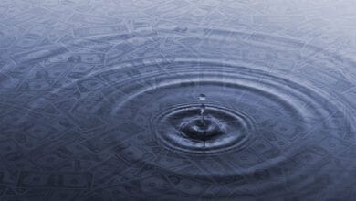 Image of drop of water in pool with dollars