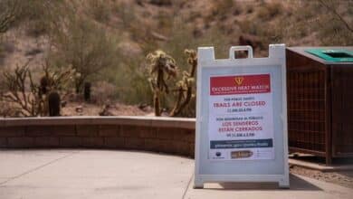 Una señal de advertencia de calor excesivo se encuentra en la entrada de un popular lugar de senderismo en Camelback Mountain en Phoenix el viernes.