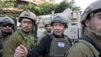 Israeli Prime Minister Benjamin Netanyahu, center, wears a protective vest and helmet as he receives a security briefing with commanders and soldiers in the northern Gaza Strip, on Monday, Dec. 25, 2023. (Avi Ohayon/GPO/Handout via AP)